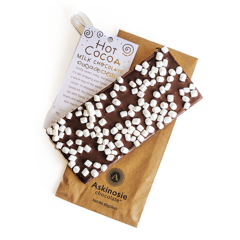 Chocolate bar with mini marshmallows laid on Kraft brown Askinosie Chocolate packaging