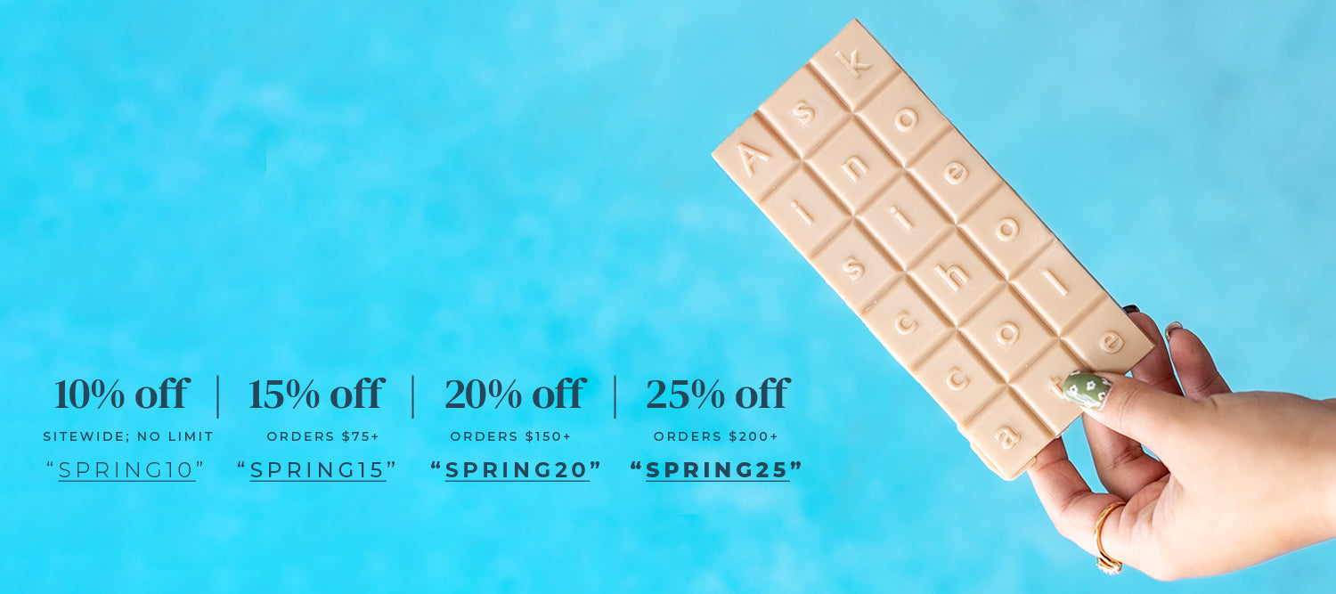 Hand holding a chocolate bar with promotional text on a blue background