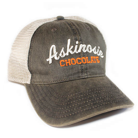 A distressed brown and khaki trucker hat embroidered with Askinosie Chocolate on the front panel
