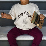 Toddler model wearing a tan t-shirt with Big Clap design